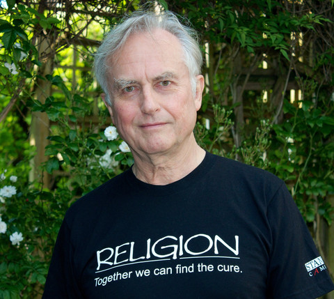 Picture of Richard Dawkins wearing a T-shirt bearing the slogan ~ Religion : Together we can find the cure